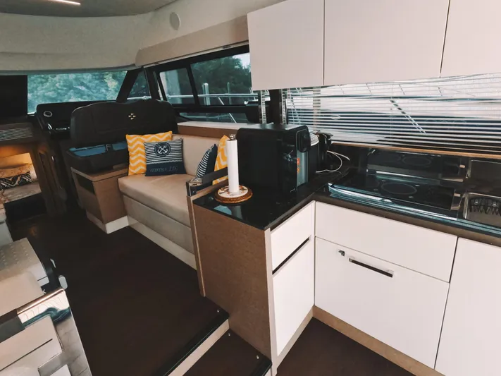  Yacht Photos Pics Interior of 2020 Prestige 460 yacht with modern kitchen and seating area.