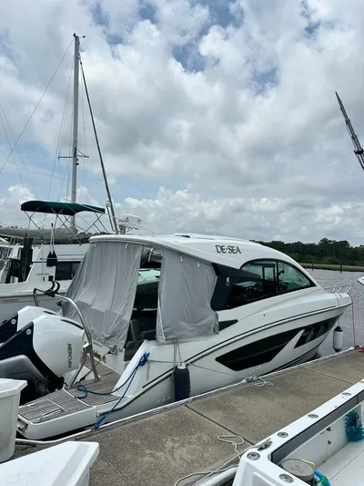 De-sea Yacht Photos Pics 2021 Beneteau GT 32 yacht docked at marina under cloudy sky.