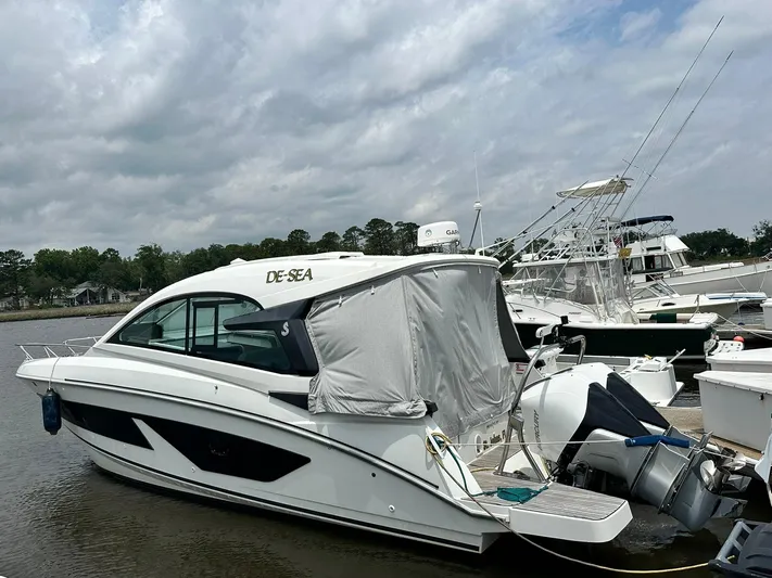 De-sea Yacht Photos Pics 2021 Beneteau GT 32 yacht docked at marina under cloudy sky.