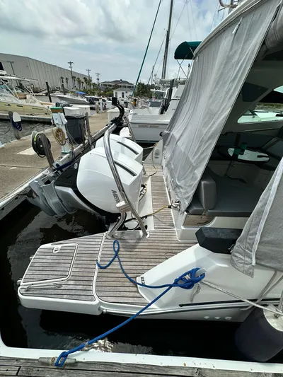 De-sea Yacht Photos Pics 2021 Beneteau GT 32 docked, showcasing rear deck and outboard motor.