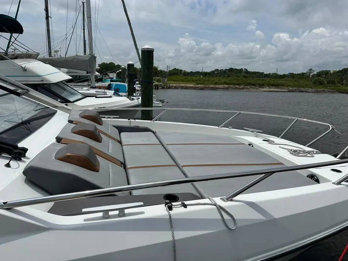 De-sea Yacht Photos Pics 2021 Beneteau GT 32 yacht docked, featuring sleek design and spacious sunbathing area.