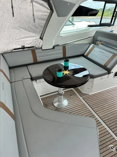 De-sea Yacht Photos Pics 2021 Beneteau GT 32 yacht interior with sleek seating and table.