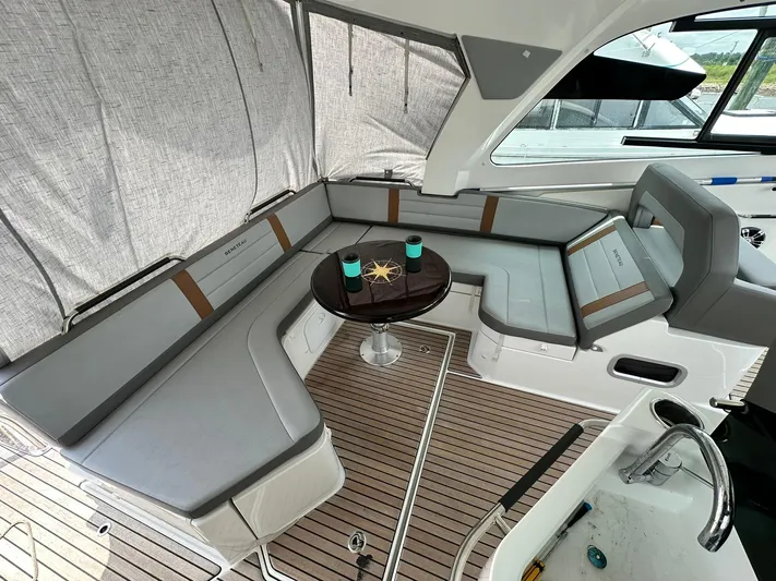 De-sea Yacht Photos Pics 2021 Beneteau GT 32 yacht interior with elegant seating and table setup.