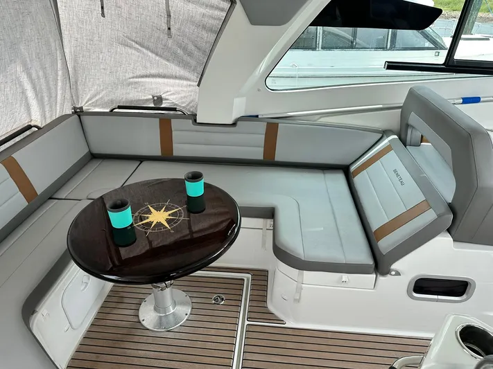 De-sea Yacht Photos Pics 2021 Beneteau GT 32 yacht interior with cushioned seating and table.