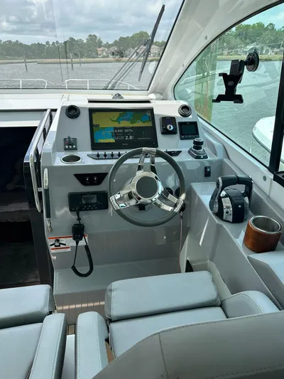 De-sea Yacht Photos Pics 2021 Beneteau GT 32 helm with modern controls and navigation system.