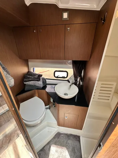 De-sea Yacht Photos Pics 2021 Beneteau GT 32 bathroom with modern fixtures, wooden cabinetry, and compact design.