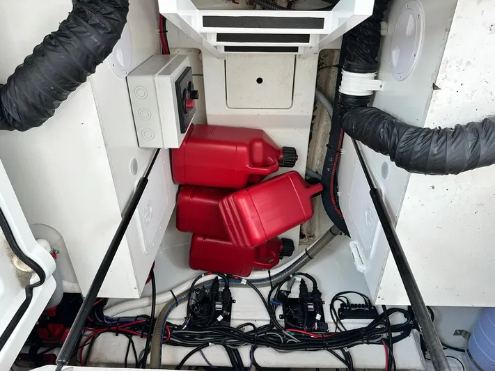 De-sea Yacht Photos Pics Engine compartment of 2021 Beneteau GT 32 with red fuel containers and wiring.