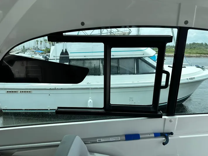 De-sea Yacht Photos Pics 2021 Beneteau GT 32 interior view with window overlooking docked boat.
