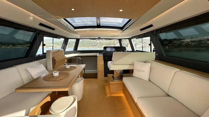 Kayenne Yacht Photos Pics Luxurious interior of 2023 Pardo Yachts GT 52 with elegant seating and panoramic windows.