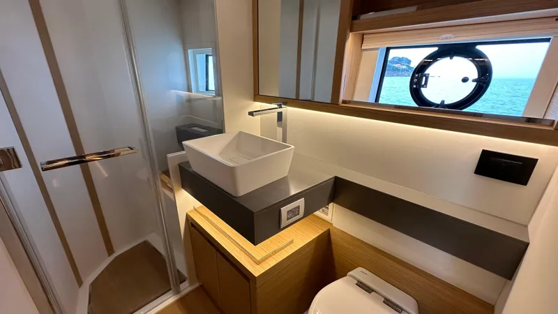 Kayenne Yacht Photos Pics Luxurious bathroom in 2023 Pardo Yachts GT 52, featuring modern sink and ocean view.