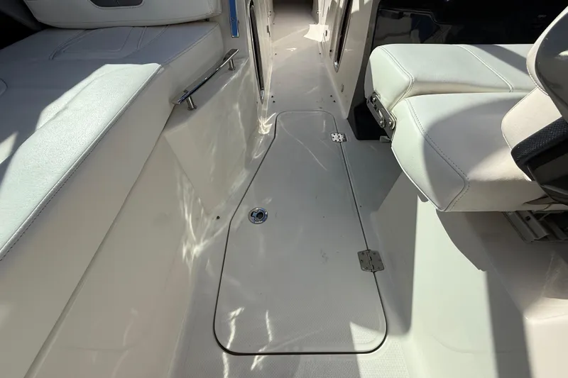  Yacht Photos Pics Interior of 2014 Monterey 328SS Super Sport boat with white seating and floor hatch.