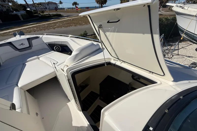  Yacht Photos Pics 2014 Monterey 328SS Super Sport boat with open storage compartment and seating area.