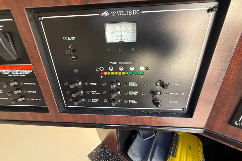  Yacht Photos Pics Control panel of a 2014 Monterey 328SS Super Sport boat, showing switches and water tank level.