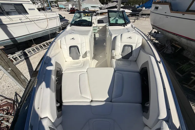  Yacht Photos Pics 2014 Monterey 328SS Super Sport boat interior with white seating, docked among other boats.