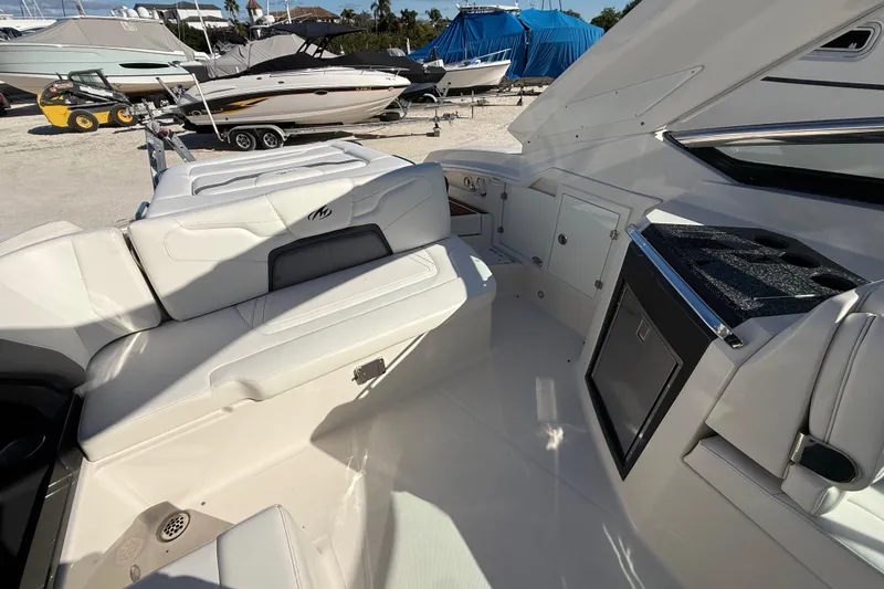  Yacht Photos Pics 2014 Monterey 328SS Super Sport boat interior with white seating and storage compartments.