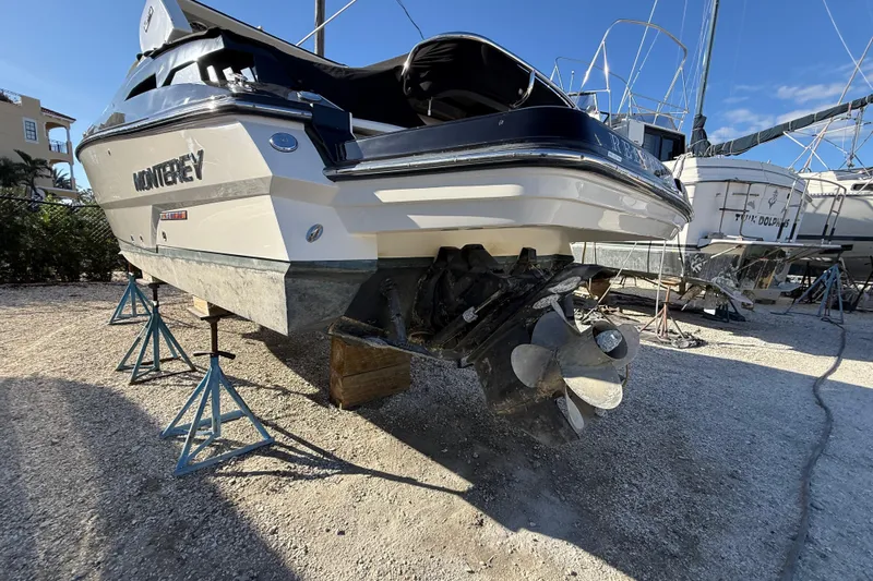  Yacht Photos Pics 2014 Monterey 328SS Super Sport boat on stands, showcasing propeller and hull.