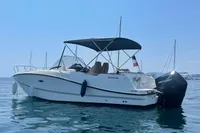 2020 Quicksilver Activ 755 Sundeck boat on calm water, featuring a sleek design and canopy.