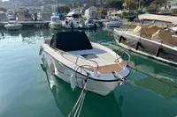 2020 Quicksilver Activ 755 Sundeck boat docked in a marina, surrounded by other vessels.