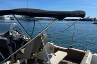 2020 Quicksilver Activ 755 Sundeck boat with canopy, docked on a sunny day.