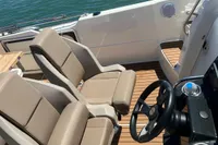 2020 Quicksilver Activ 755 Sundeck boat interior with beige seats and steering wheel.