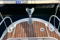 2020 Quicksilver Activ 755 Sundeck boat docked, featuring wooden deck and anchor.