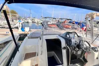 2020 Quicksilver Activ 755 Sundeck boat docked at marina, featuring sleek design and spacious deck.