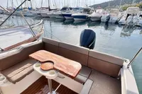 2020 Quicksilver Activ 755 Sundeck boat interior with seating and table, docked at marina.