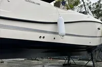 2020 Quicksilver Activ 755 Sundeck boat on stands, with canopy and fender, in outdoor setting.