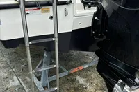 2020 Quicksilver Activ 755 Sundeck with ladder and outboard motor on a trailer.