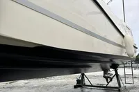 2020 Quicksilver Activ 755 Sundeck boat on stands, side view, overcast sky.