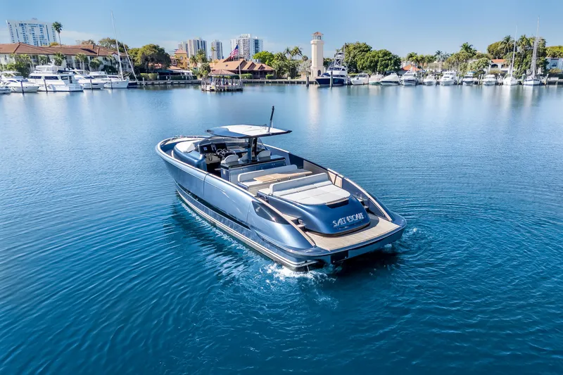 Salt Escape Yacht Photos Pics 2021 Solaris Power 48 OPEN yacht cruising in a serene marina setting.