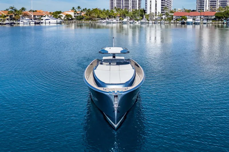 Salt Escape Yacht Photos Pics 2021 Solaris Power 48 OPEN yacht on calm water, with a scenic marina backdrop.