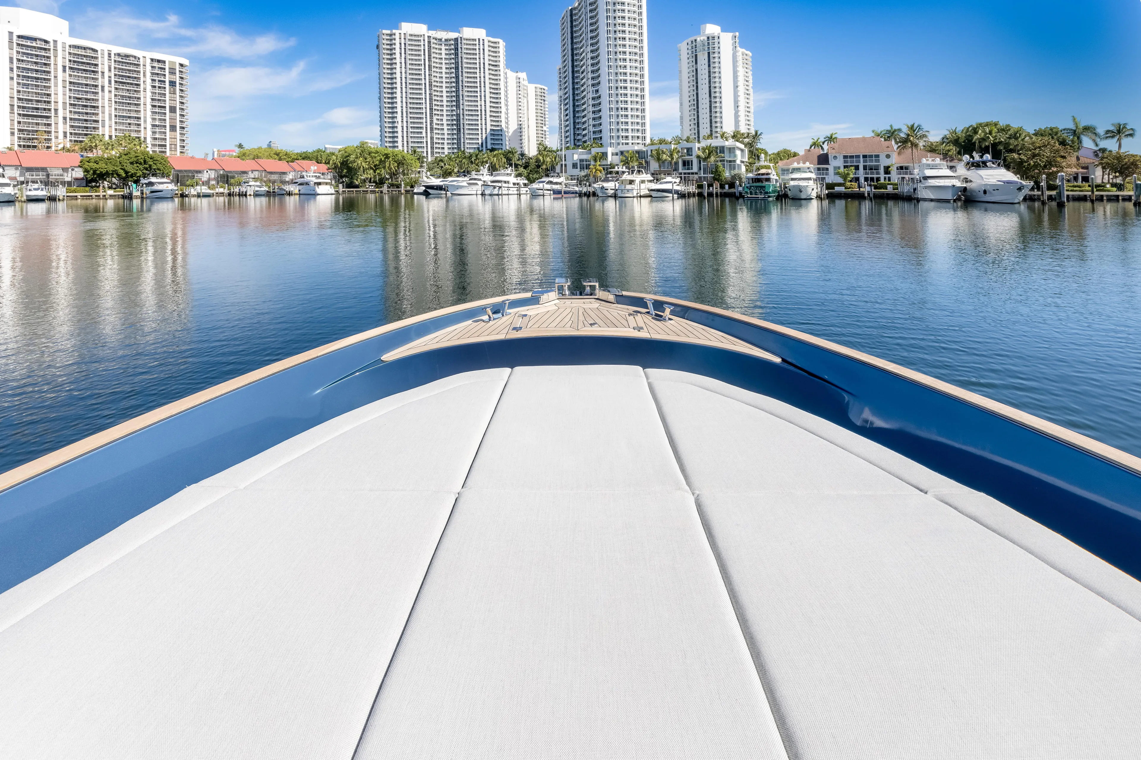 Salt Escape Yacht Photos Pics 2021 Solaris Power 48 OPEN yacht in a marina with city skyline backdrop.