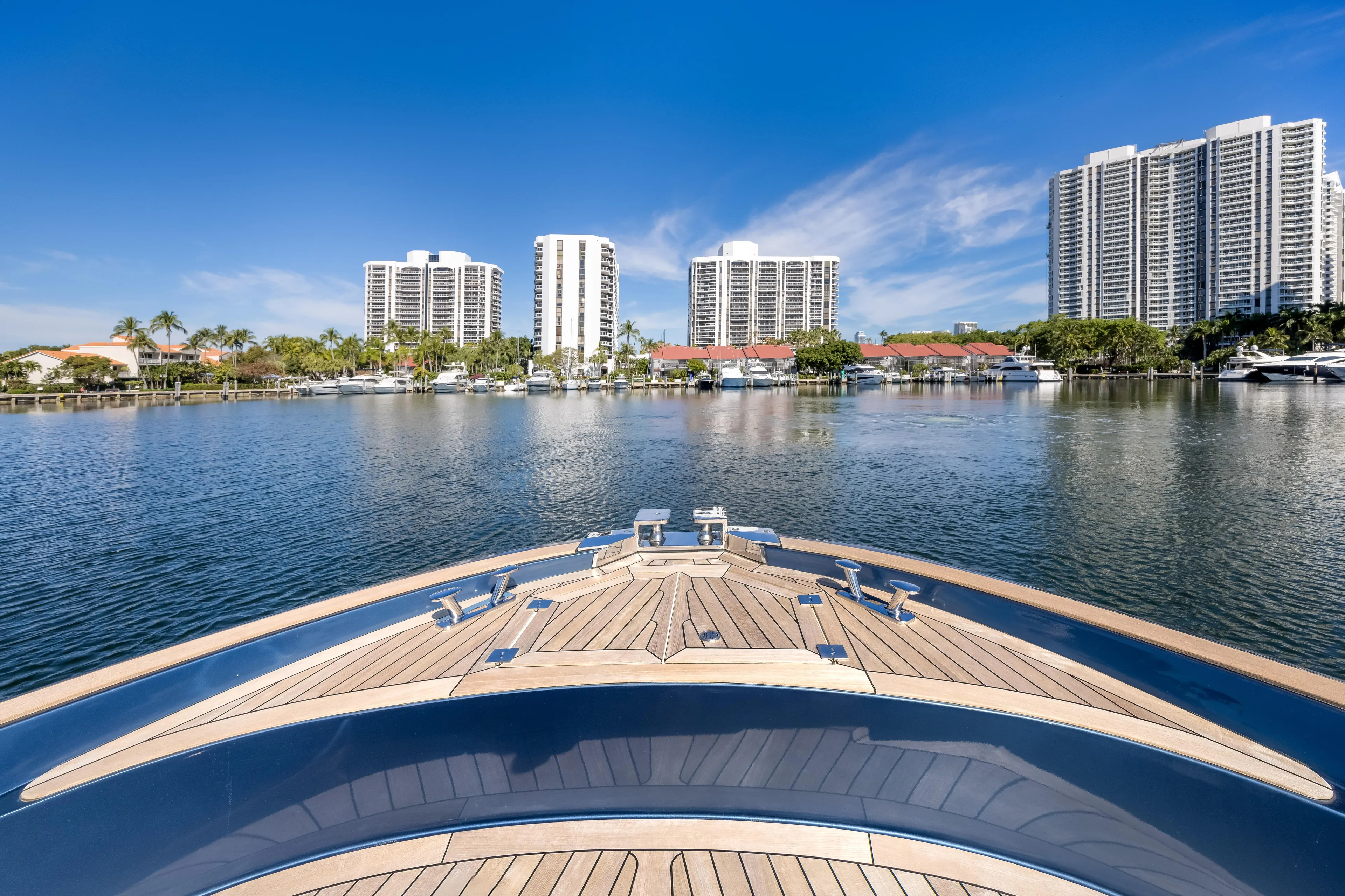 Salt Escape Yacht Photos Pics Bow view of 2021 Solaris Power 48 OPEN yacht in a marina with skyscrapers.