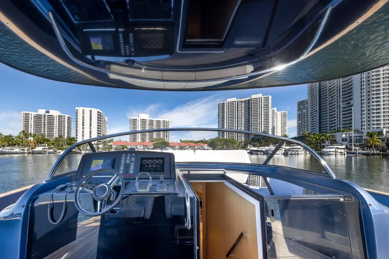 Salt Escape Yacht Photos Pics Cockpit view of 2021 Solaris Power 48 OPEN yacht with city skyline backdrop.
