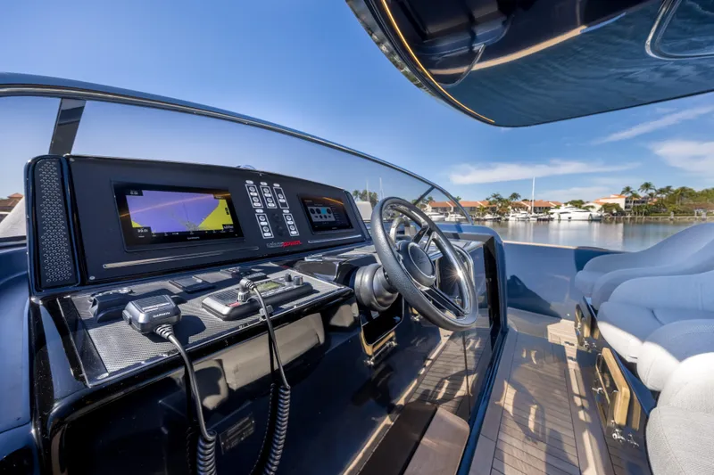 Salt Escape Yacht Photos Pics Cockpit of 2021 Solaris Power 48 OPEN yacht with modern navigation equipment and steering wheel.