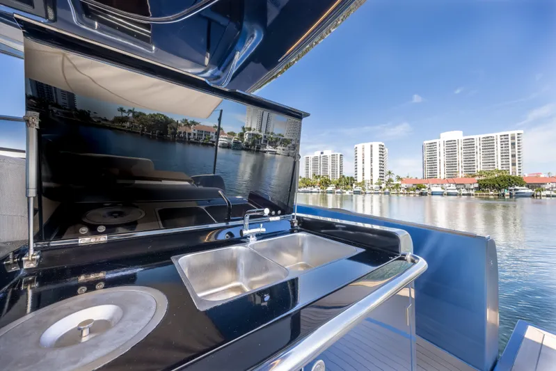 Salt Escape Yacht Photos Pics Solaris Power 48 OPEN 2021 yacht with outdoor sink and cityscape view.