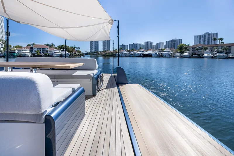 Salt Escape Yacht Photos Pics 2021 Solaris Power 48 OPEN yacht with elegant deck, city skyline, and waterfront view.