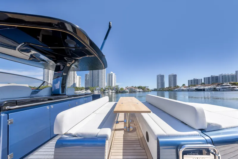 Salt Escape Yacht Photos Pics 2021 Solaris Power 48 OPEN yacht with sleek design, docked in a modern city marina.