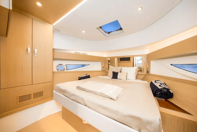 Salt Escape Yacht Photos Pics Luxurious cabin interior of 2021 Solaris Power 48 OPEN yacht, featuring elegant wood finishes.