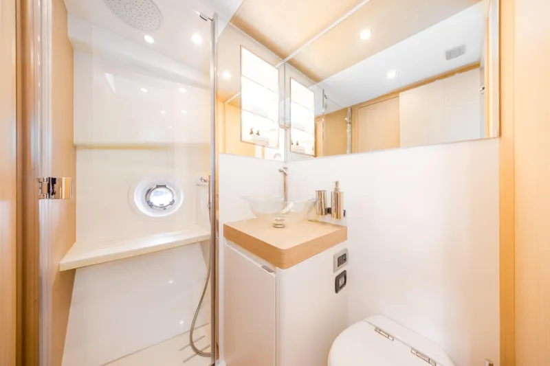 Salt Escape Yacht Photos Pics Luxurious bathroom interior of 2021 Solaris Power 48 OPEN yacht, featuring modern fixtures and elegant design.