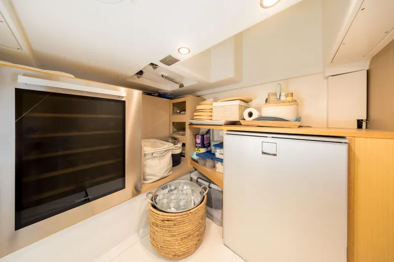 Salt Escape Yacht Photos Pics Interior storage area of 2021 Solaris Power 48 OPEN yacht with shelves and appliances.