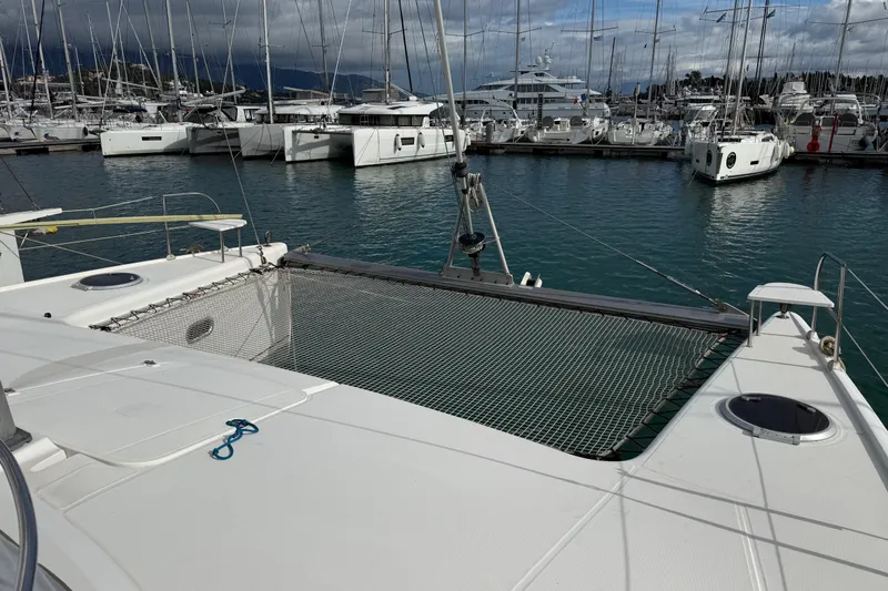  Yacht Photos Pics 2003 Fountaine Pajot Belize 43 catamaran docked in a marina, featuring a netted deck area.