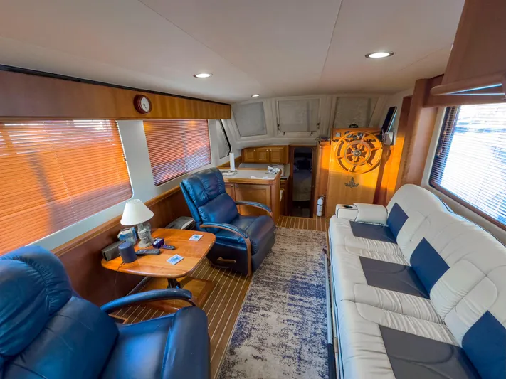Vitamin Sea Yacht Photos Pics Interior of 2005 Mainship 34 Trawler with plush seating and wooden accents.