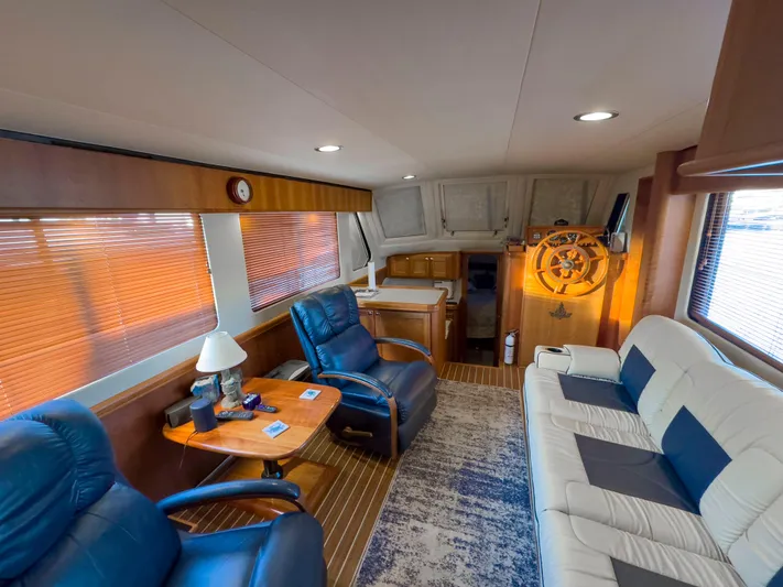 Vitamin Sea Yacht Photos Pics Interior of 2005 Mainship 34 Trawler with plush seating and wooden helm.