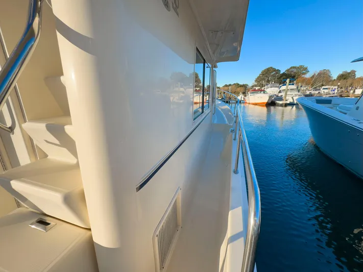 Vitamin Sea Yacht Photos Pics 2005 Mainship 34 Trawler docked, side view with clear blue sky and water.