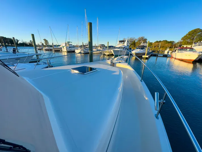 Vitamin Sea Yacht Photos Pics 2005 Mainship 34 Trawler docked in a marina under clear blue skies.