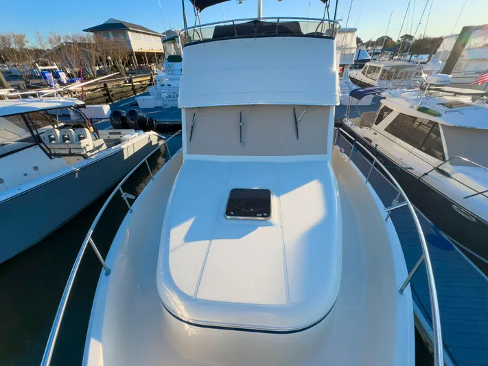 Vitamin Sea Yacht Photos Pics 2005 Mainship 34 Trawler docked among other boats in a marina.