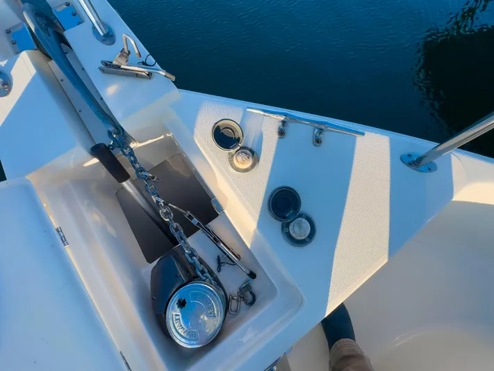 Vitamin Sea Yacht Photos Pics Anchor system on 2005 Mainship 34 Trawler, docked on calm water.