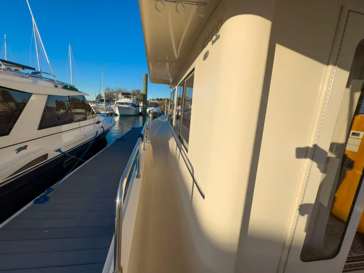 Vitamin Sea Yacht Photos Pics 2005 Mainship 34 Trawler docked at marina under clear blue sky.